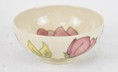 Lot 460 - MOORCROFT; a cream ground bowl decorated in...