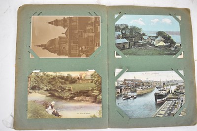 Lot 443 - Three early stamp albums and a postcard album,...