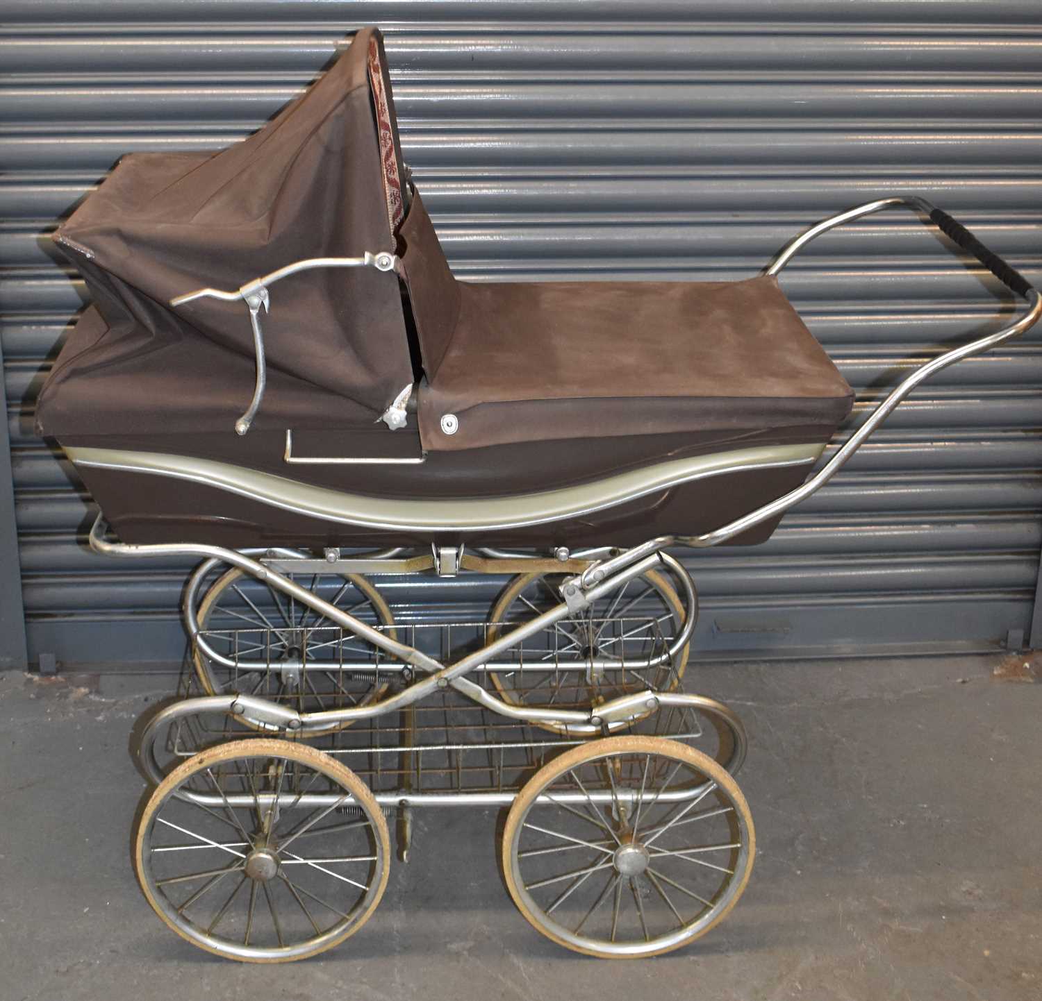 Lot 230 - A Silver Cross pram, height 112cm.