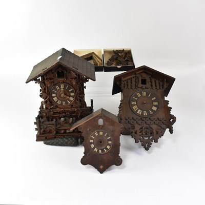 Lot 157 - A group of three wooden cuckoo clocks, height...