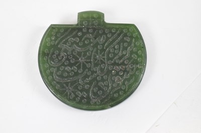 Lot 569 - An Islamic carved green hardstone seal, height...