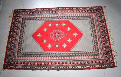 Lot 100 - An early 20th century hand knotted red ground...