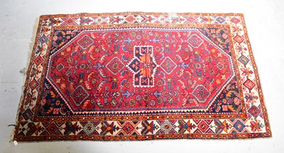 Lot 130 - A hand knotted red ground carpet, with...