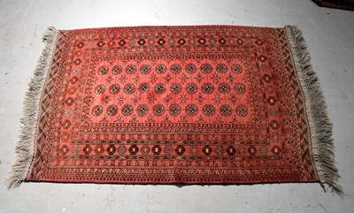 Lot 131 - A hand knotted red ground carpet decorated...