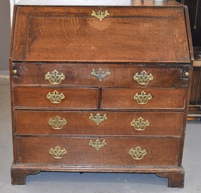 Lot 26 - An 18th century oak bureau, the fall front...