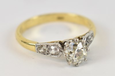 Lot 670 - An 18ct gold diamond ring, the central stone...