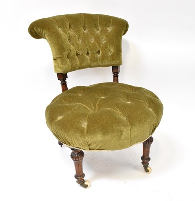 Lot 79 - A button press green velour upholstered low...