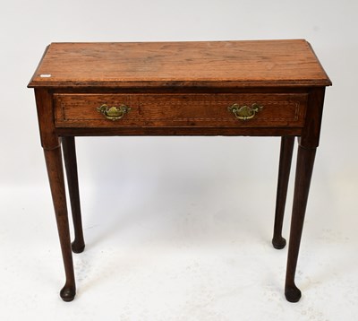 Lot 101 - A Georgian oak single-drawer side table raised...