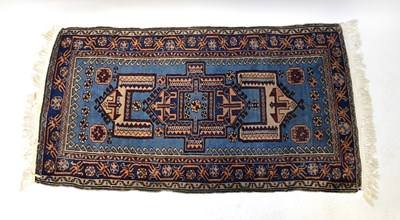 Lot 132 - A hand knotted blue ground carpet with two...