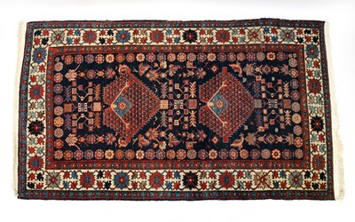 Lot 133 - A hand knotted blue ground carpet with central...