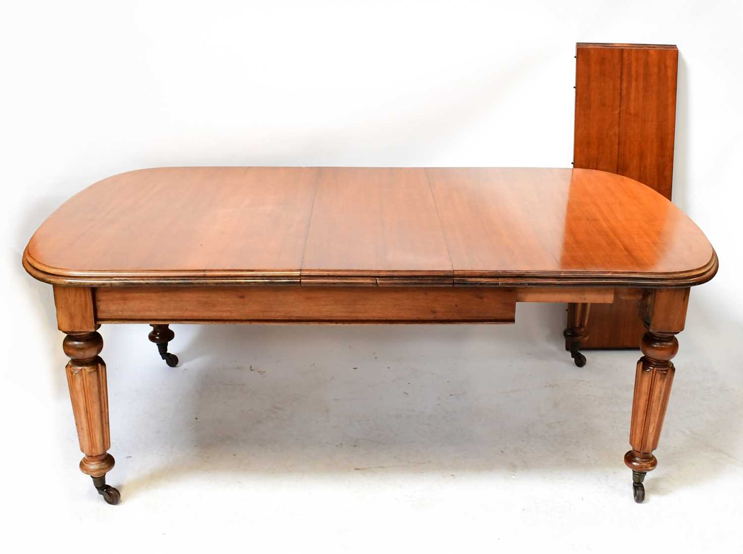 Lot 87 - A Victorian mahogany wind-out dining table