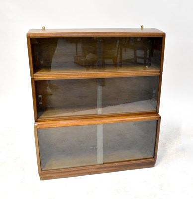 Lot 35 - A three-section stacking bookcase with sliding glass doors