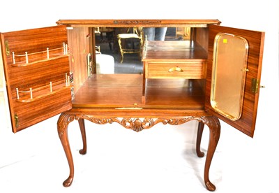 Lot 28 - A reproduction walnut veneered cocktail...