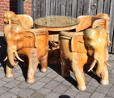 Lot 4 - A large modern carved hardwood elephant...