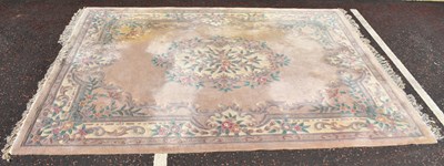 Lot 68 - A modern Chinese floral and beige carpet,...