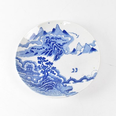 Lot 420 - An Oriental blue and white plate painted with...