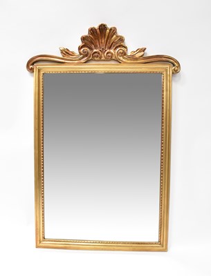 Lot 114 - A reproduction gilt framed wall mirror with...