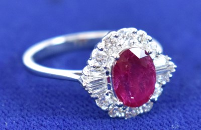 Lot 672 - An 18ct white gold oval ruby and diamond...