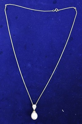 Lot 688 - A 9ct yellow gold necklace suspending a pear...