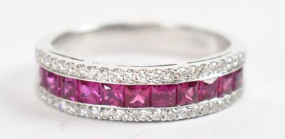 Lot 675 - An 18ct white gold three banded ruby and...