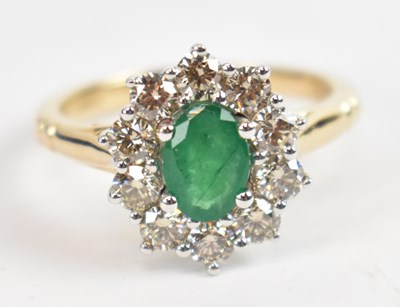 Lot 707 - A 9ct white and yellow gold oval emerald and...