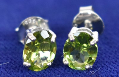 Lot 759 - A pair of silver ear studs set with peridot.