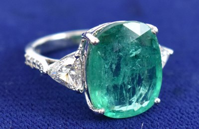 Lot 667 - An 18ct white gold oval cushion cut emerald...