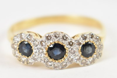 Lot 715 - An 18ct yellow gold sapphire and diamond three...