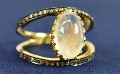 Lot 753 - A gold plated silver split shank oval cabochon...