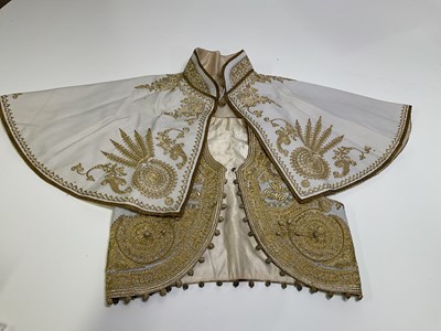 Lot 131 - An Asian child's gold embroidered and beaded...