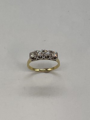 Lot 1156 - A 18ct yellow gold four stone diamond ring,...