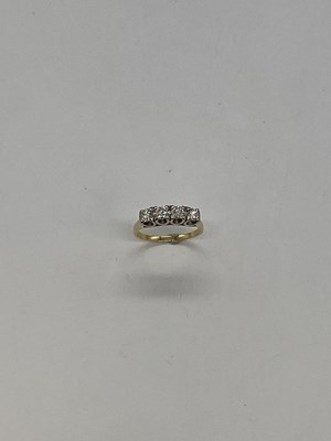 Lot 1156 - A 18ct yellow gold four stone diamond ring,...