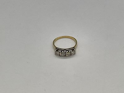 Lot 1156 - A 18ct yellow gold four stone diamond ring,...