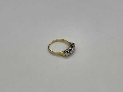 Lot 1156 - A 18ct yellow gold four stone diamond ring,...