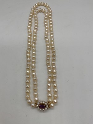 Lot 399 - A hand tied double strand of pearls with 9ct...