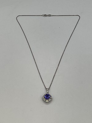 Lot 375 - An 18ct white gold diamond and tanzanite...