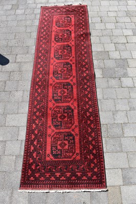 Lot 124 - A modern Afghan-style runner, with a central...