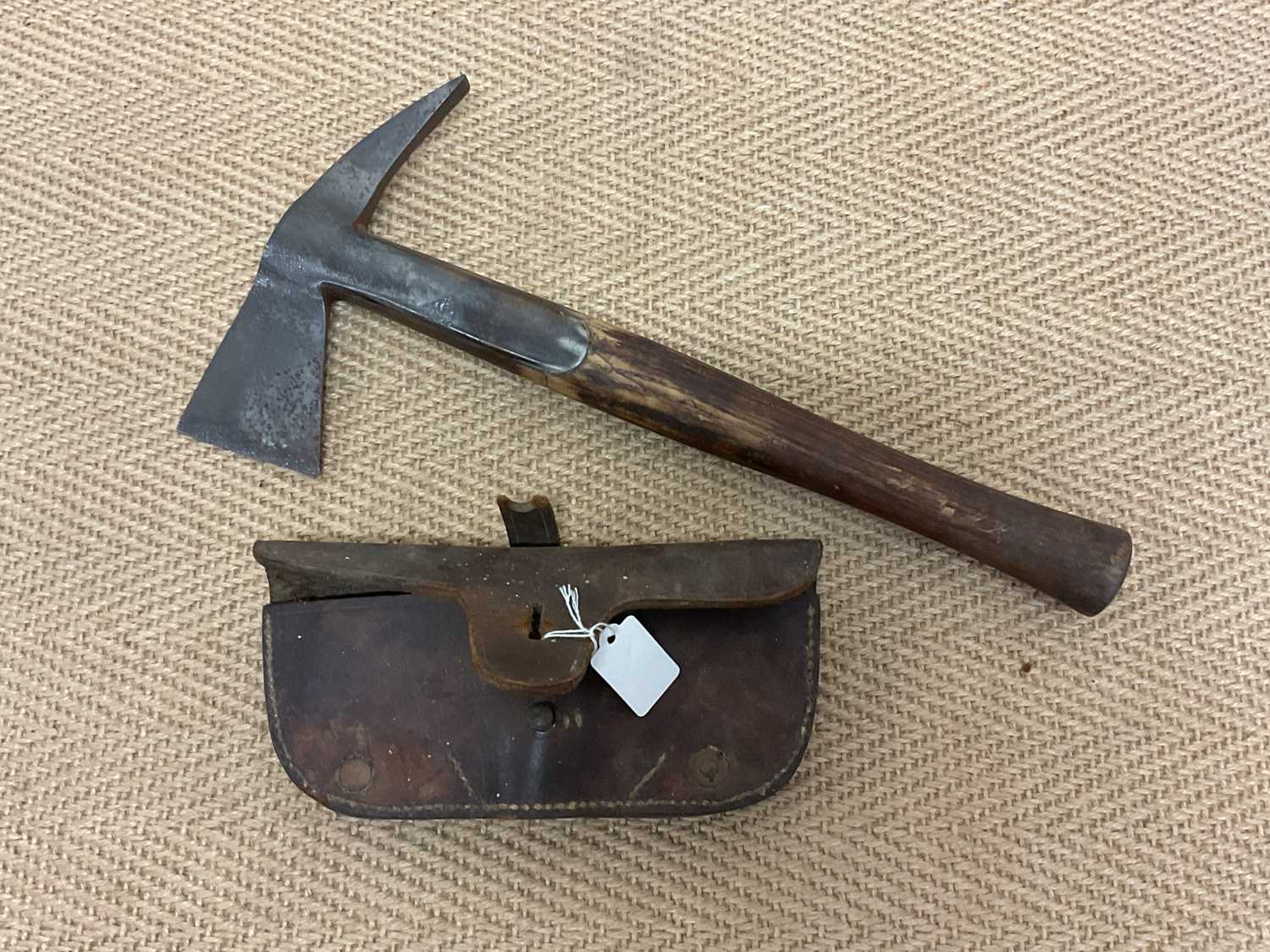 Lot 71 A fireman's axe together with leather sheath.