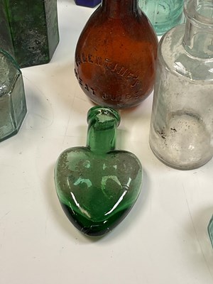 Lot 61 - A quantity of glass bottles, a brass kettle on...