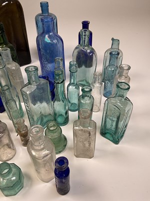 Lot 61 - A quantity of glass bottles, a brass kettle on...