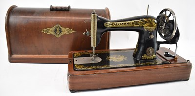 Lot 241 - A walnut cased Singer sewing machine.