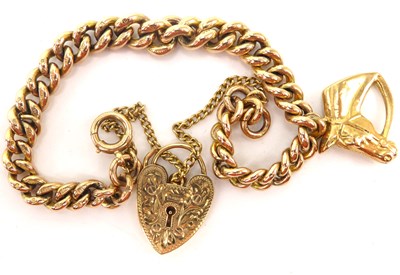 Lot 1017 - A 9ct gold bracelet with horse head pendant...