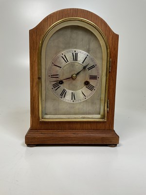 Lot 325 - An Edwardian oak mantel clock, with arched...