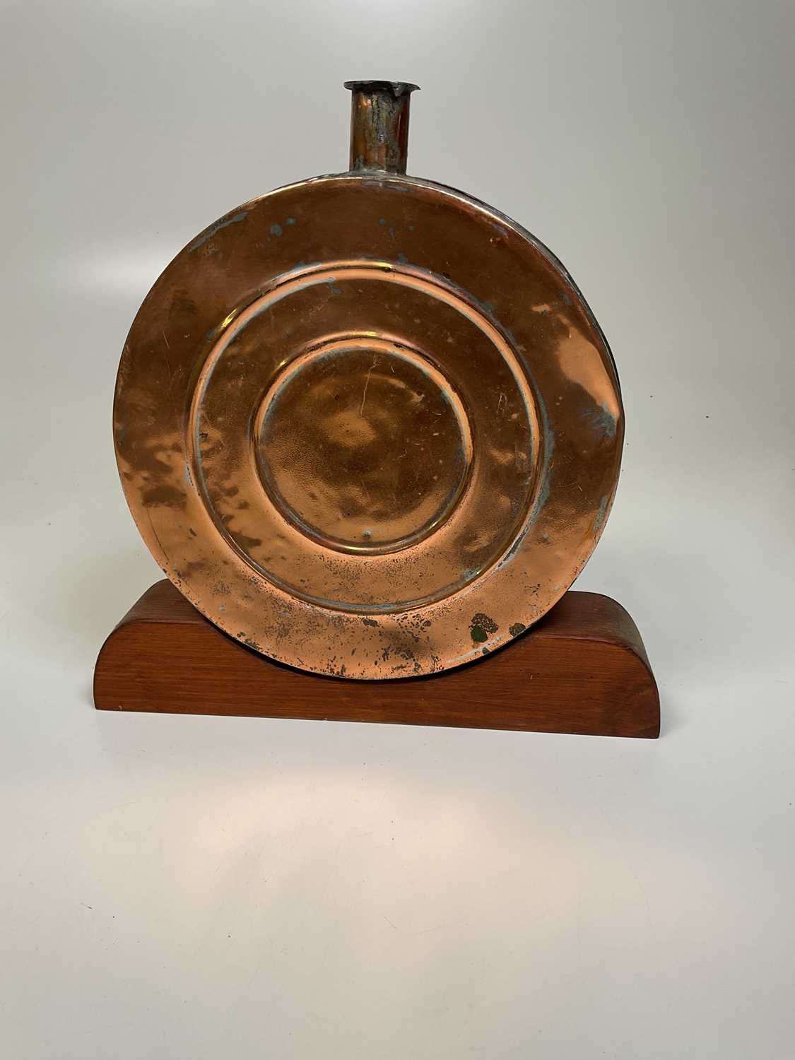 Lot 110 - A decorative copper flask on wooden plinth, 34...