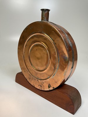 Lot 110 - A decorative copper flask on wooden plinth, 34...