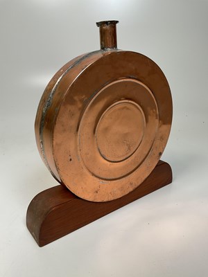 Lot 110 - A decorative copper flask on wooden plinth, 34...