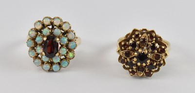 Lot 740 - A 9ct yellow gold opal and garnet dress ring,...