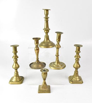 Lot 343 - A pair of brass candlesticks and four similar...