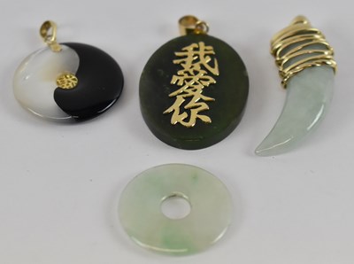 Lot 772 - A group of four Chinese hardstone pendants,...