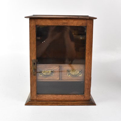 Lot 171 - An early 20th century oak smokers' cabinet,...